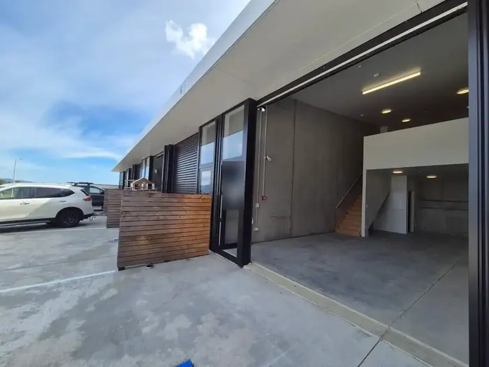 Unit 6 with the roller door open, showing the warehouse, stairs and mezzanine