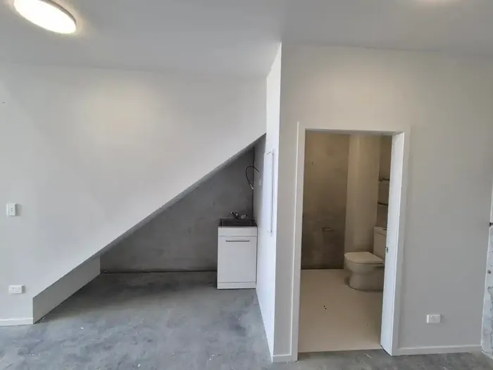 Ground floor tub under the stairs and the toilet