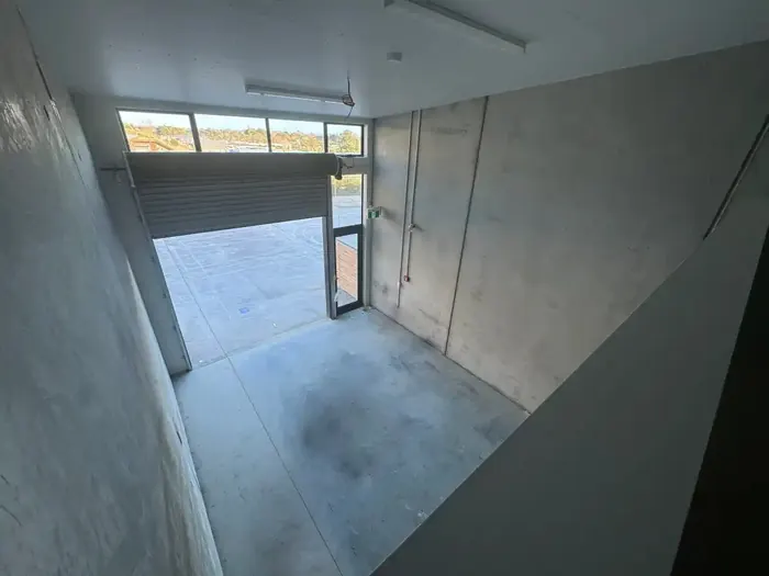 View down from the mezzanine to the warehouse floor and roller door